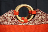 Boat-shaped Handbag with Wooden handle and embellished with beads.